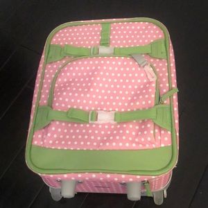 pink suitcase with white polka dots